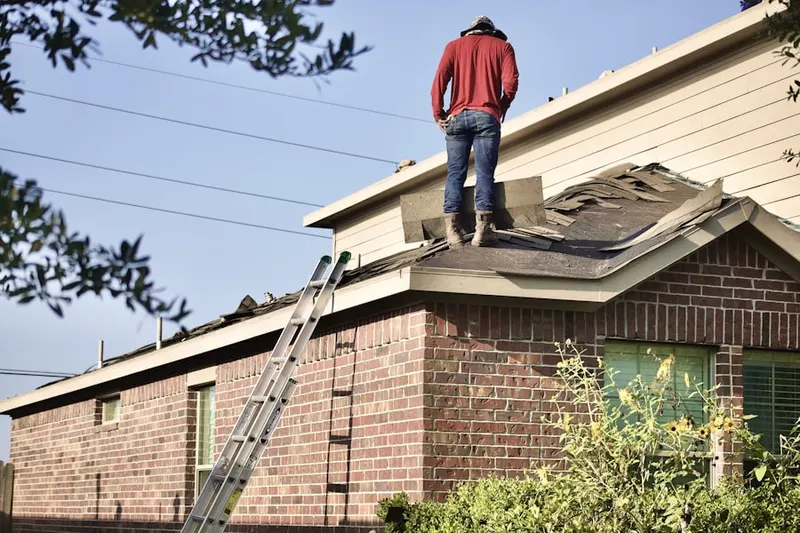Professional roofer working on a residential roof in Haworth